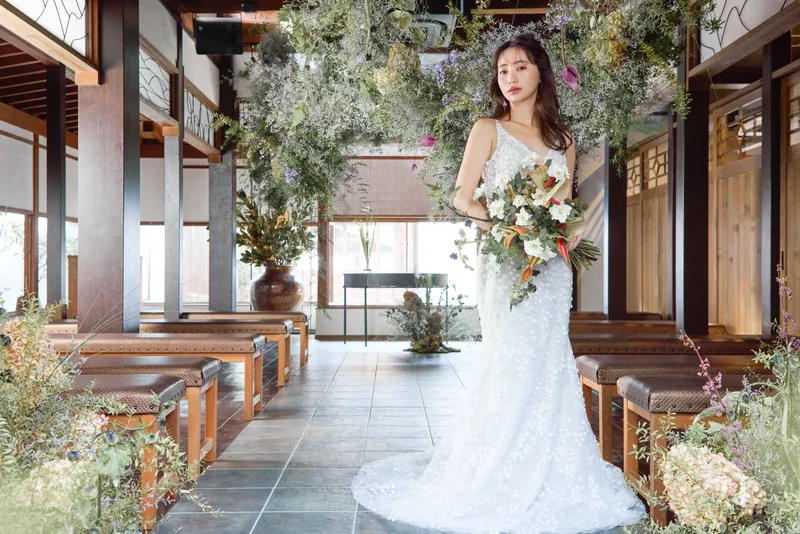 Bride walking through the softly lit Yuikado chapel in Kurashiki